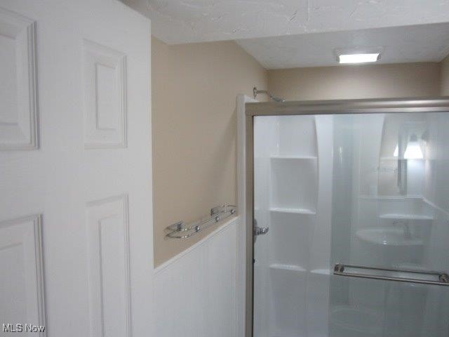 bathroom with a shower with shower door