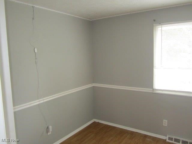 unfurnished room featuring wood-type flooring