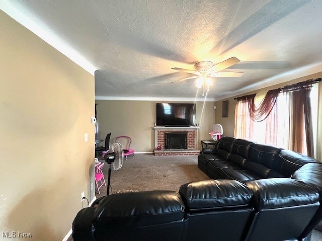 living room with a fireplace, a textured ceiling, carpet, and ceiling fan