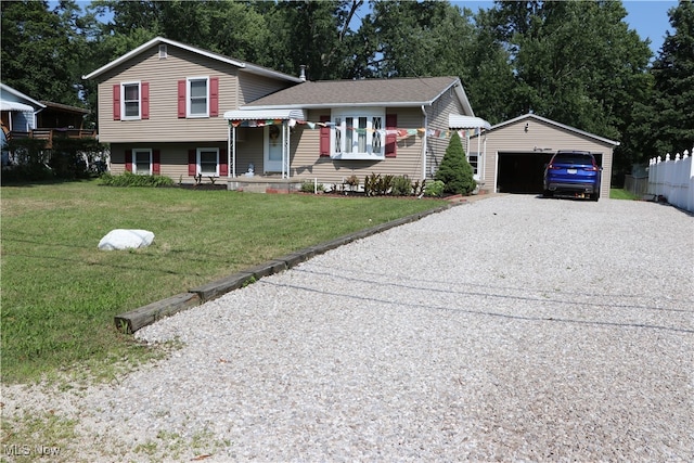 tri-level home featuring a garage, an outdoor structure, and a front lawn