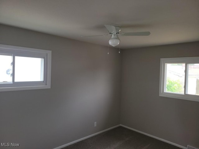 carpeted spare room featuring ceiling fan