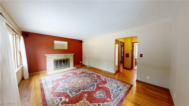 living room featuring wood-type flooring and a fireplace