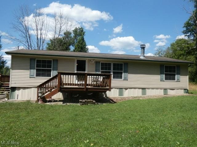 back of property featuring a yard and a deck