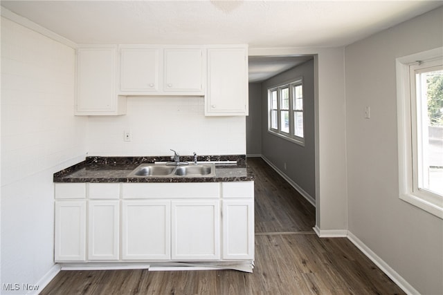 kitchen with dark hardwood / wood-style floors, white cabinets, and sink