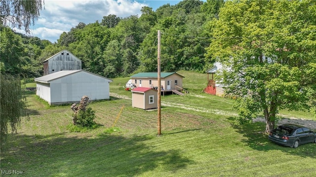 view of yard featuring a storage shed and a deck