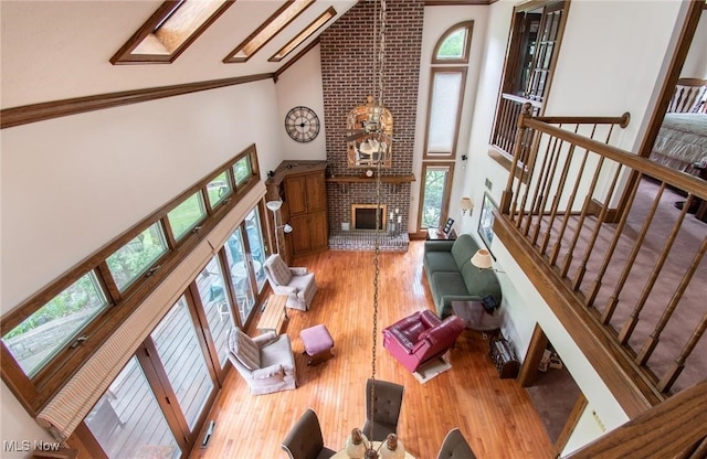347 State Route 14, Columbiana, OH 44408 - living room with high vaulted ceiling, ornamental molding, wood finished floors, a brick fireplace, and stairs