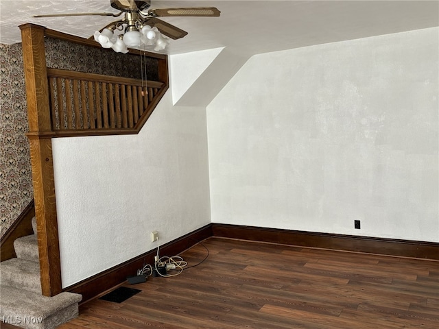 staircase with ceiling fan and hardwood / wood-style floors