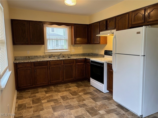 kitchen featuring dark brown cabinetry, sink, light stone countertops, and white appliances