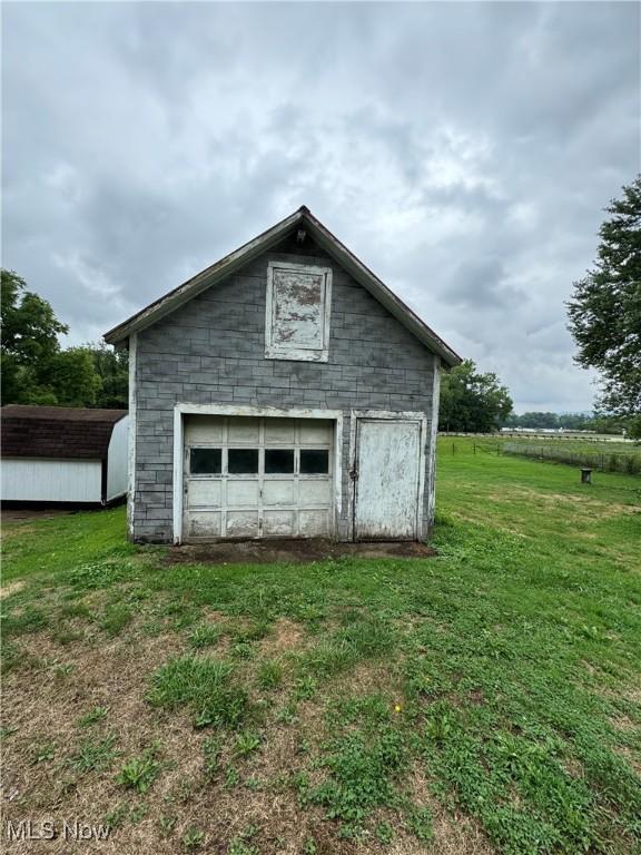 garage featuring a yard