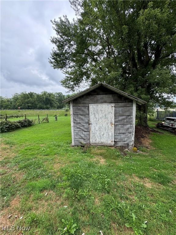 view of outbuilding featuring a lawn