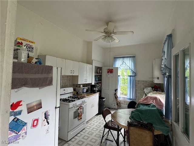 kitchen featuring white cabinetry, white appliances, and ceiling fan