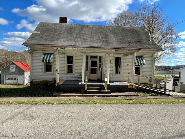 618 Market St, Clarington, OH 43915 - cape cod-style house featuring a chimney and covered porch