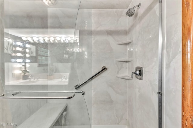 bathroom featuring sink and a shower with door