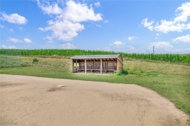 view of community featuring a rural view and an outdoor structure