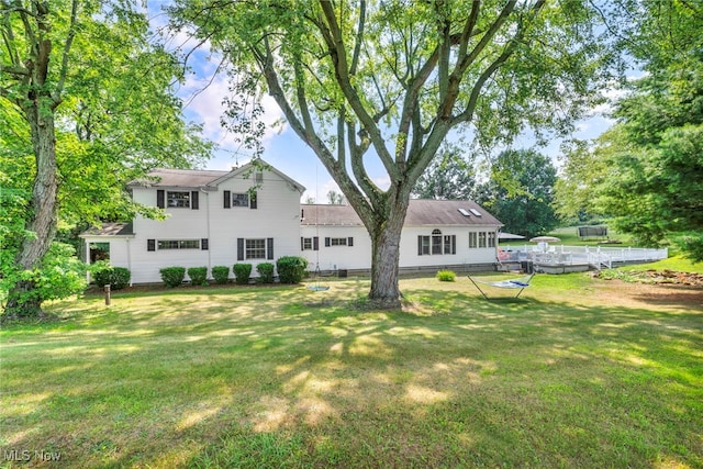 rear view of property featuring a yard