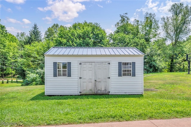 view of outbuilding featuring a lawn