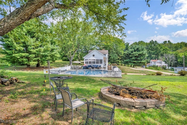 view of yard with an outdoor structure and an outdoor fire pit