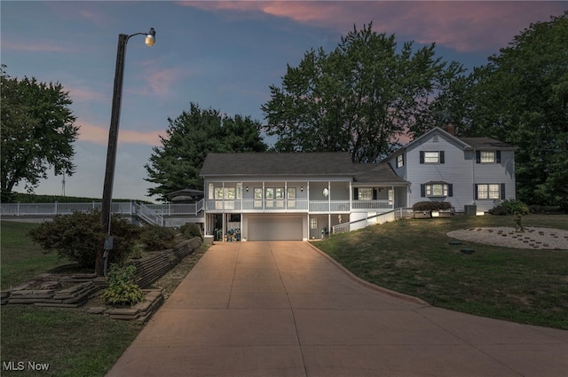 view of front of property with a garage and a yard