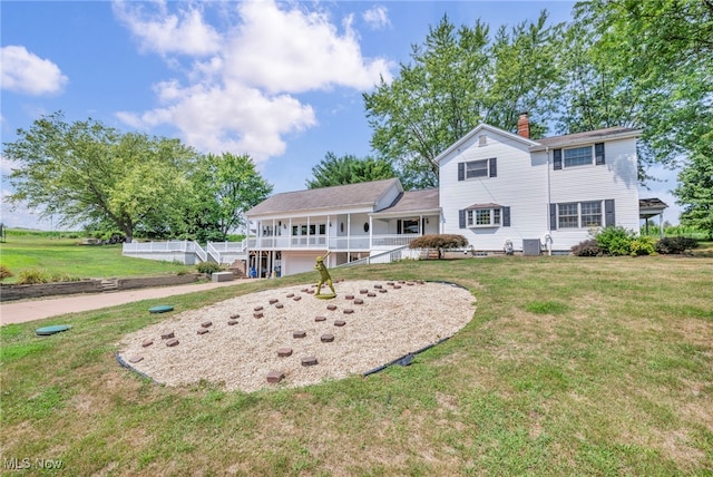 view of front of home featuring a deck and a front yard