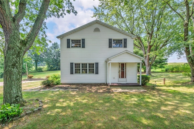 view of front of house featuring covered porch and a front yard