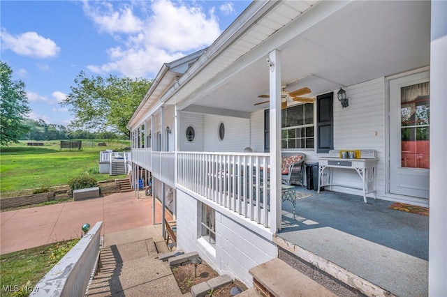 exterior space featuring a patio, a yard, ceiling fan, and covered porch