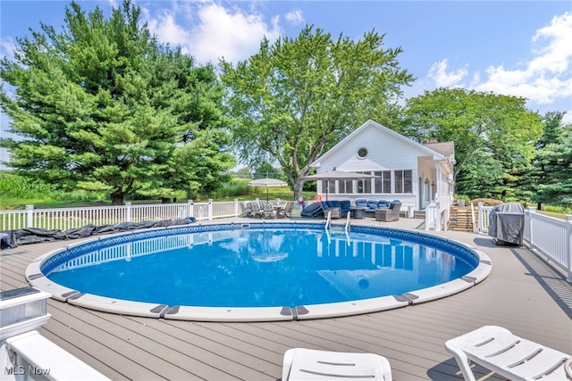 view of swimming pool with a wooden deck