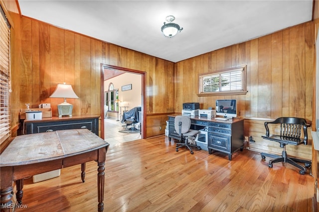 home office featuring wood walls and light wood-type flooring