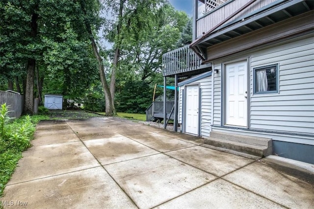 view of patio featuring an outbuilding and a storage unit