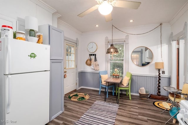 interior space featuring ornamental molding, dark hardwood / wood-style flooring, white refrigerator, and ceiling fan