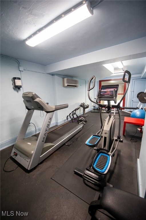 interior space featuring a wall mounted air conditioner and baseboards