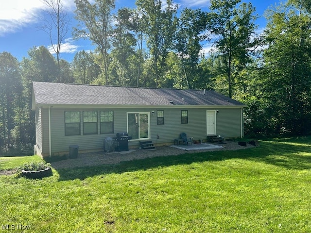 back of property featuring a lawn and a patio