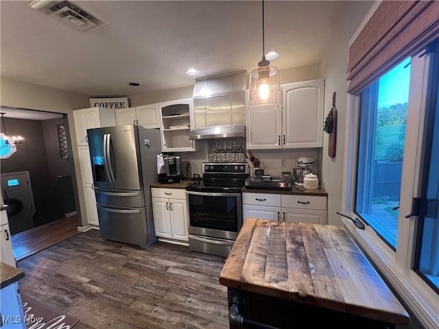 kitchen featuring appliances with stainless steel finishes, dark wood-style flooring, visible vents, and white cabinets