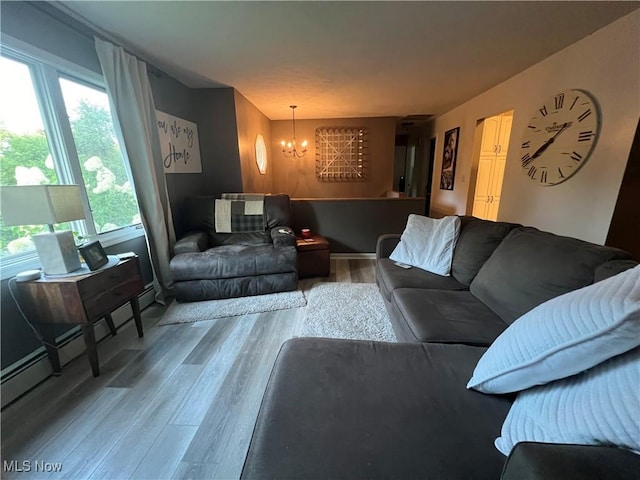 living area with wood finished floors and a notable chandelier