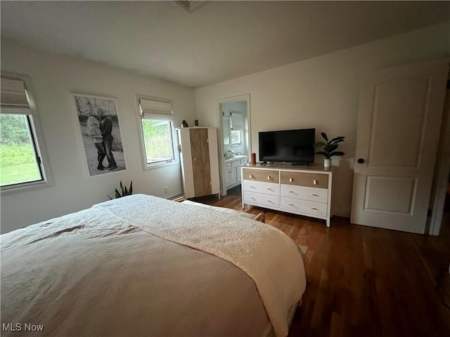 bedroom with dark wood-style flooring