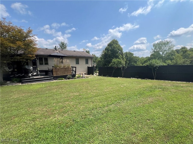 view of yard featuring fence and a wooden deck