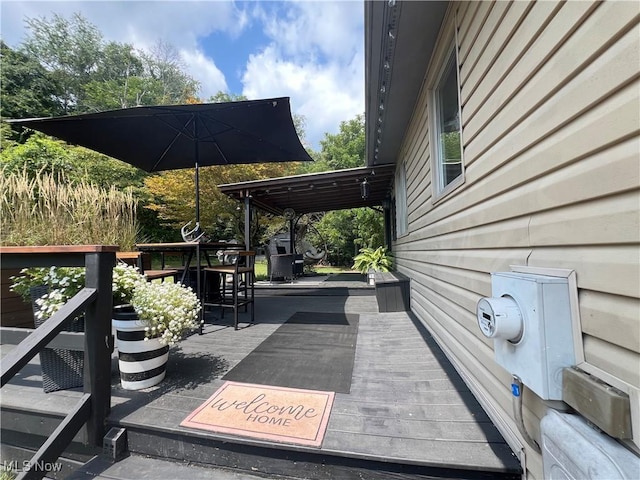 wooden terrace with outdoor dining area