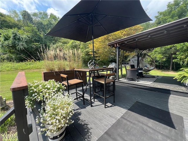 wooden deck featuring a storage shed, outdoor dining space, and an outdoor structure