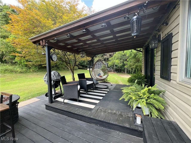 wooden deck with a lawn