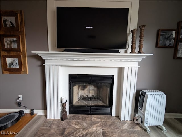 details with a fireplace and baseboards