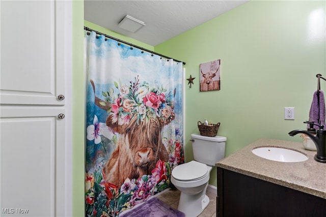 bathroom featuring vanity, toilet, and tile patterned floors