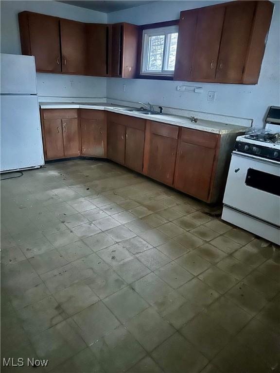 kitchen featuring sink and white appliances