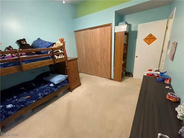 bedroom with light carpet and a closet