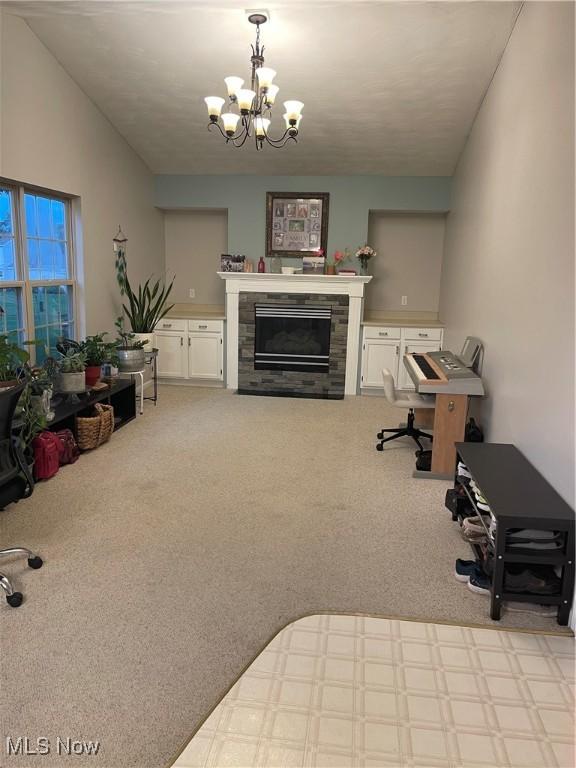 carpeted living room with an inviting chandelier and a fireplace