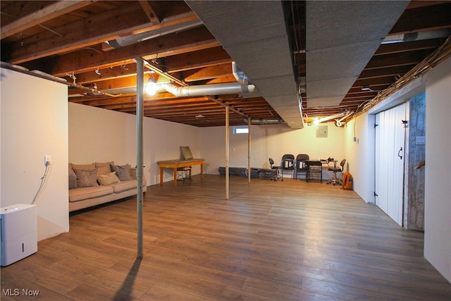 basement with hardwood / wood-style flooring