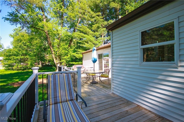 wooden deck featuring a yard