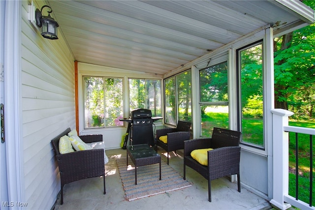 sunroom / solarium featuring vaulted ceiling