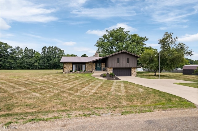 tri-level home featuring a garage and a front yard