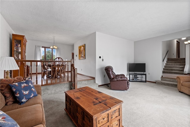 carpeted living room with a textured ceiling and a chandelier