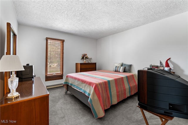 carpeted bedroom with a baseboard radiator and a textured ceiling