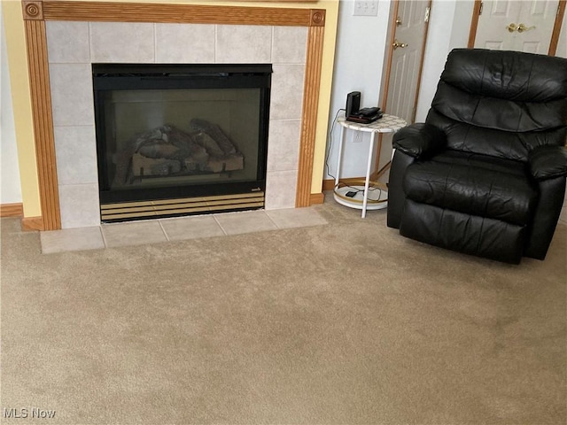 sitting room with carpet floors and a tile fireplace